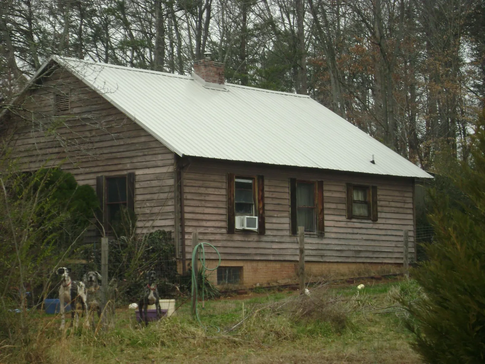 White metal roof on an old wood sided farmhouse, from a Metal Roof Installation job in North Conway